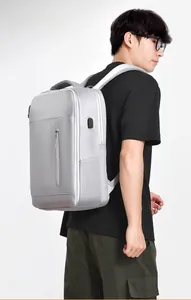 Side view of gray commuter backpack featuring an external USB port and ergonomic straps