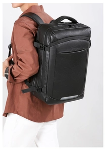 Detail of black faux leather business backpack featuring side buckles and reflective strip