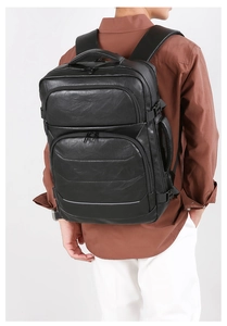 Business laptop backpack with ergonomic padded shoulder straps and premium leather texture