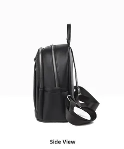 Side view showing the litchi grain leather texture and zipper compartments of the backpack