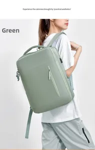 Detail of light green business backpack showing side USB charging port and fabric texture
