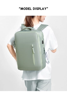 Detail view of water-resistant green business backpack with USB port on a model back
