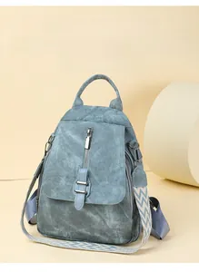 Detail of grey-blue PU leather backpack with geometric pattern woven shoulder strap