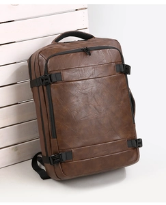 Detail of premium brown PU leather backpack texture with buckle and padded handle