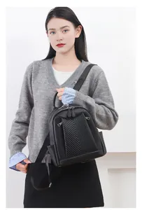 Detail of elegant black lychee texture leather backpack with stylish V-shaped quilting