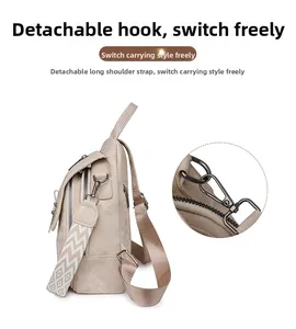 Detail of detachable metal hook and woven strap on beige PU leather backpack