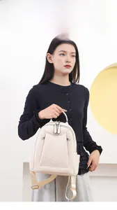 Model wearing a mini off-white backpack with chevron stitching and adjustable straps