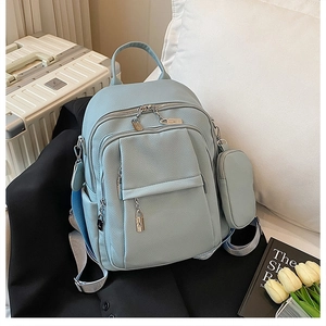 Detailed view of light blue lychee texture backpack with heart zippers and coin purse