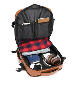 Detailed view of the brown leather backpack open with multi-compartment storage system