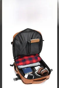 Internal view of high-capacity brown leather backpack showing organized storage compartments