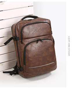 Detail view of brown faux leather business backpack featuring retro lychee texture