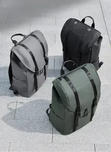 Waterproof matte backpacks in grey, black, and green with buckle straps and flap closure