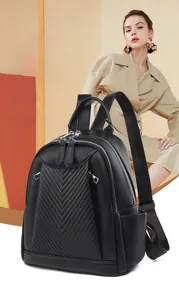 Detail of black chevron quilted leather backpack with dual zippers and side pocket texture