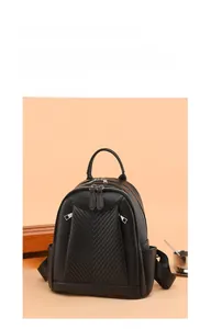 Detail of black pebbled leather backpack with V-shaped quilting and dual zippers