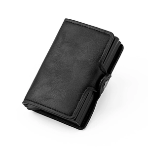 Detail view of black lychee grain texture and metal buckle on RFID pop-up card holder