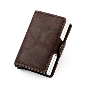 Detail view of brown RFID aluminum card holder with side snap button closure and leather texture