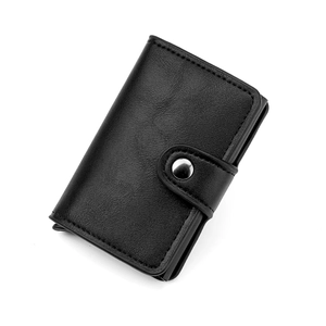 Detail of black leather RFID wallet showing pebbled texture and metal snap closure