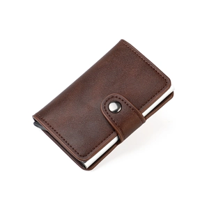 Close-up of brown leather RFID wallet with neat stitching and silver metal pop-up card slot
