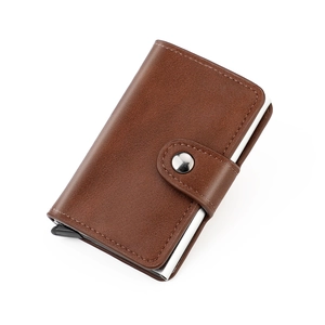 Macro detail of dark brown leather RFID wallet showing card popup mechanism and stitching
