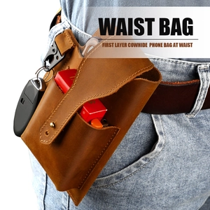 Detail of vintage brown cowhide leather waist bag with metal buckle and belt loop