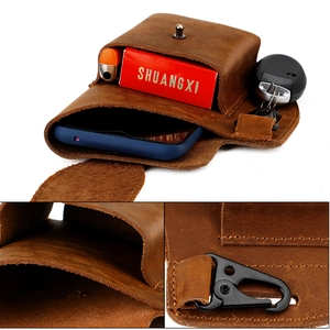 Detail of vintage leather waist bag showing internal compartments and durable metal hardware