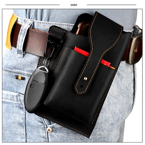 Detail of black leather waist bag with orange stitching and tactical metal carabiner