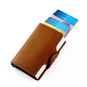 Detail view of brown pebbled leather RFID wallet with automatic pop-up aluminum card holder