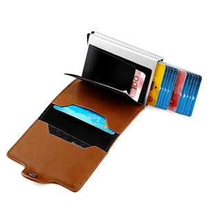 Detail view of brown leather RFID card holder with double aluminum pop-up slots and snap closure