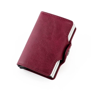 Detail view of burgundy pebble leather RFID wallet with dual metal card slots and snap closure