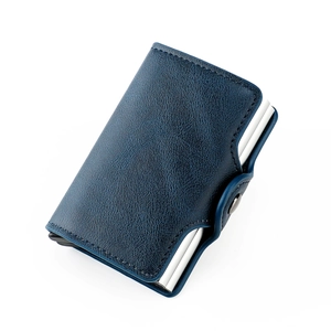 Detail of navy blue pebble leather wallet with RFID blocking metal pop-up card mechanism