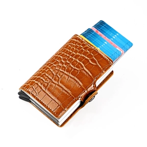 Detail of brown crocodile pattern wallet with silver aluminum RFID-blocking pop-up card case