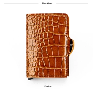 Macro shot of brown crocodile texture RFID wallet with secure button strap and pop-up lever