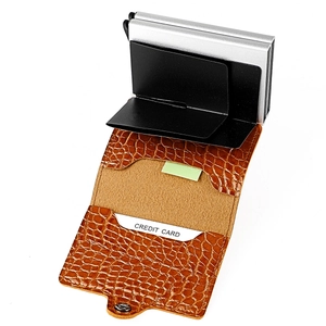 Detail view of brown crocodile leather RFID card holder with automatic pop-up mechanism