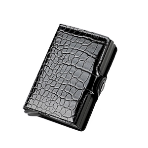 Detail of RFID blocking wallet with black crocodile texture and automatic metal card ejector