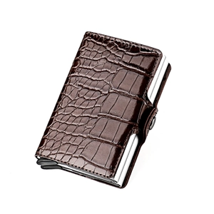 Macro shot of brown crocodile pattern leather cardholder with RFID silver aluminum frame