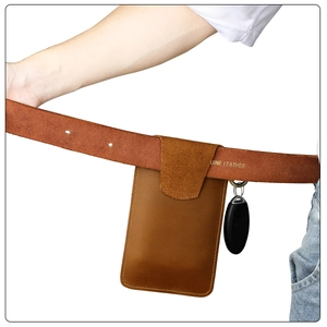 Brown leather phone holster on belt with side metal clip for car keys and front flap