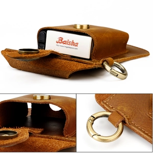 Macro detail of crazy horse leather belt pouch with brass snap and metal spring hook