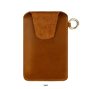 Detail view of the back of a vintage brown leather belt pouch with stitching and clip