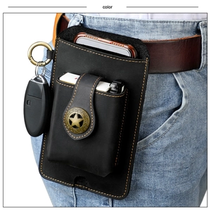 Detail of vintage black leather cell phone belt pouch with lighter pocket and key ring