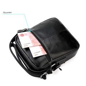Detailed view of the zip pocket on a black leather crossbody bag for men