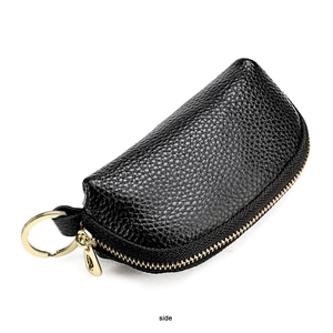 Side view of black pebble grain leather car key pouch with gold zipper and keyring