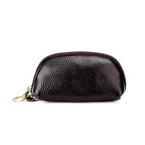 Close-up of brown lychee grain leather key pouch with a gold metal zipper and ring