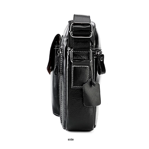 Side view of black leather shoulder bag showing layered design and white stitching details
