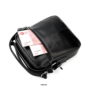 Detailed internal view of black leather crossbody bag showing the front zipper pocket