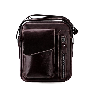 Macro detail of dark brown leather texture and stitching on mens vertical crossbody bag