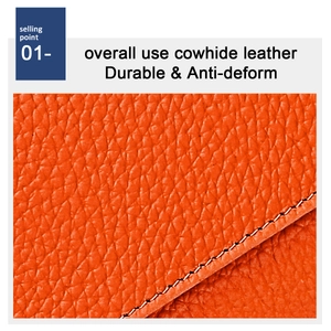 Macro shot of orange lychee grain cowhide leather and durable stitching on wallet