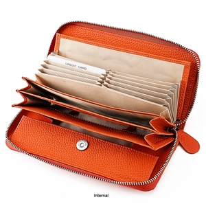 Detail view of orange leather wallet interior with 11 accordion card slots and button pocket
