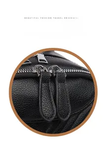 Detail of premium black litchi leather backpack with smooth metal double zippers and leather pulls