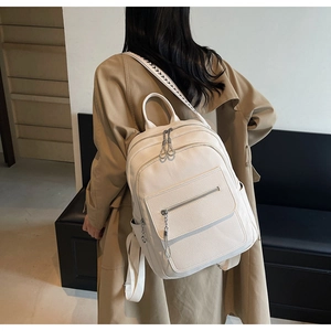 Detail of white pebbled leather backpack with unique geometric pattern shoulder straps