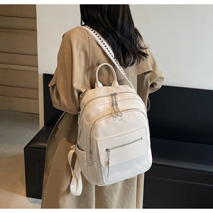 Detailed view of white litchi pattern backpack with black and white geometric wide straps
